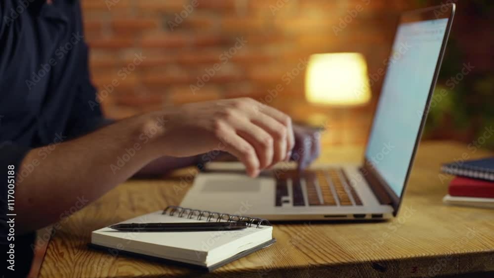 Close up of businessman working with laptop in office at night. Slow motion. Close up of businessman working with laptop in office at night. Slow motion.