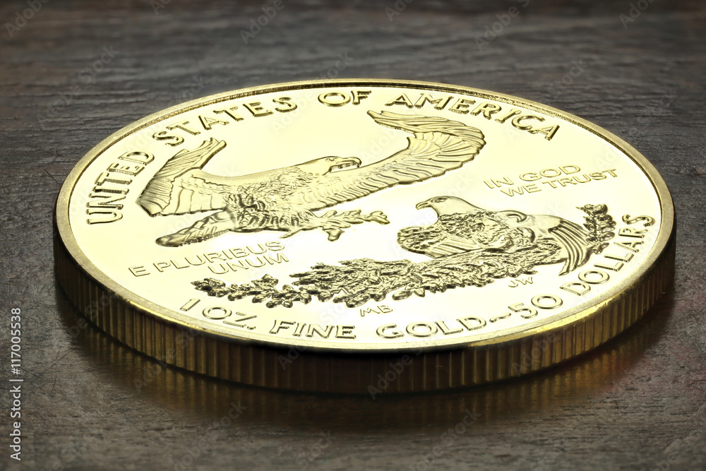 1 ounce American gold eagle bullion coin on wooden background 1 ounce American gold eagle bullion coin on wooden background