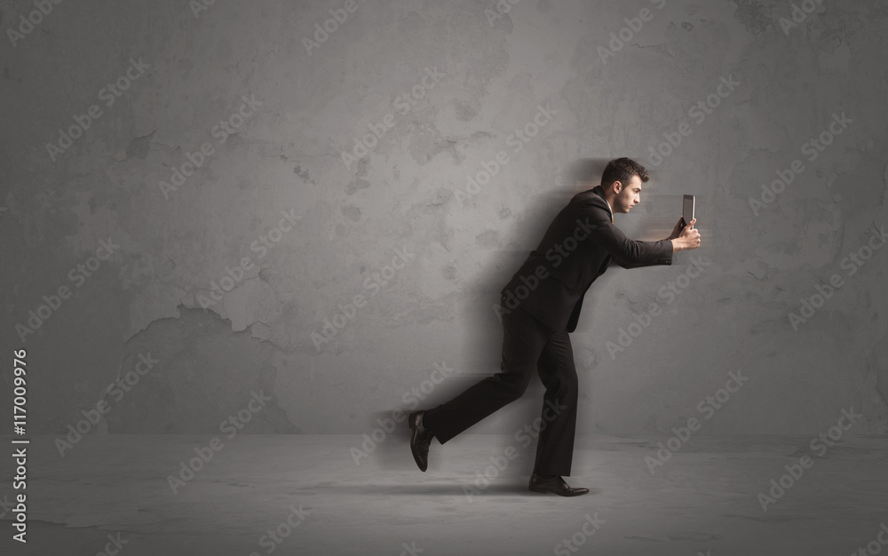 Running businessman with device in hand Running businessman with device in hand