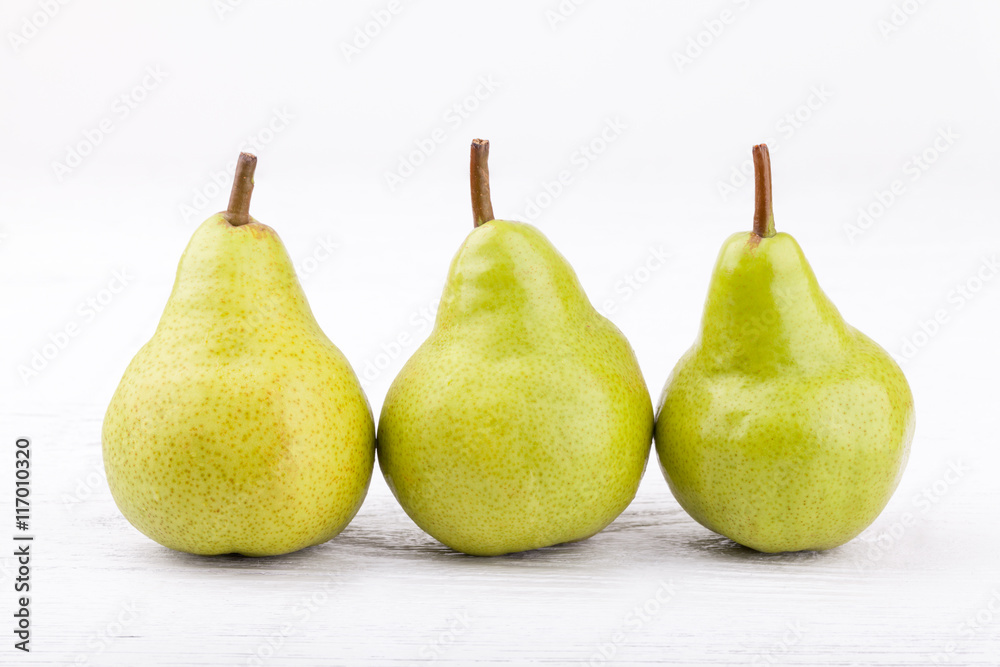 green pears on white wooden background.. green pears on white wooden background..