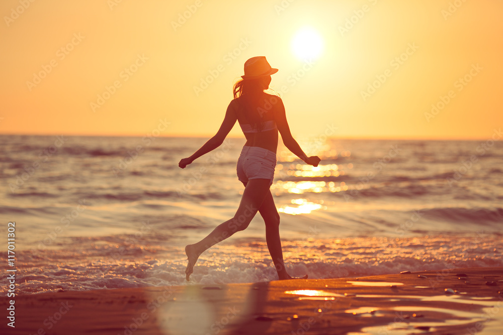Running barefoot on the beach