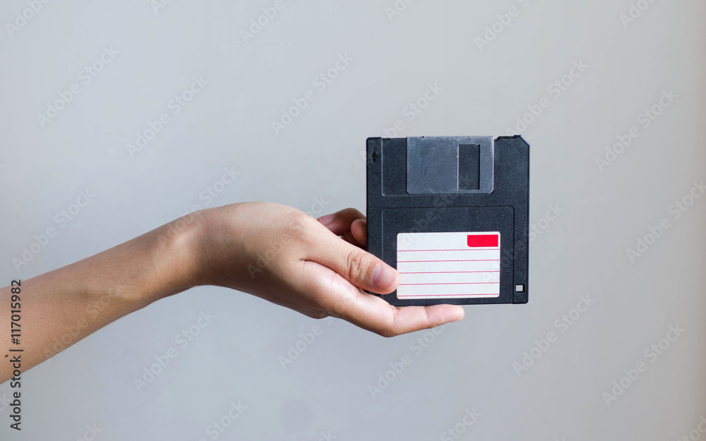 Closeup image: hand holding blackFloppy Disk data storage Closeup image: hand holding blackFloppy Disk data storage