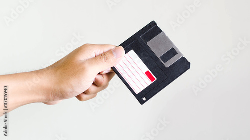 Closeup image: hand holding blackFloppy Disk data storage