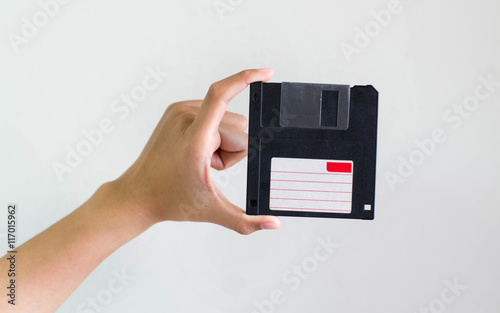 Closeup image: hand holding blackFloppy Disk data storage