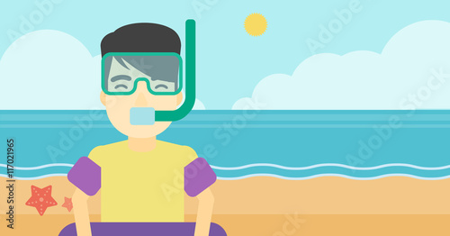 Man with snorkeling equipment on the beach.