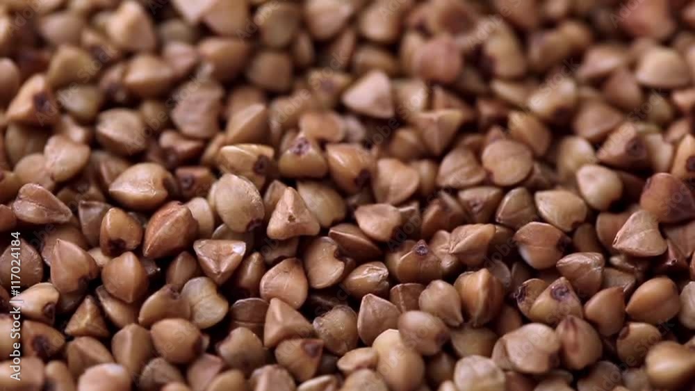Rotating raw buckwheat. Spinning closeup dry uncooked seeds. 1280x720. Slow Motion Rotating raw buckwheat. Spinning closeup dry uncooked seeds. 1280x720. Slow Motion