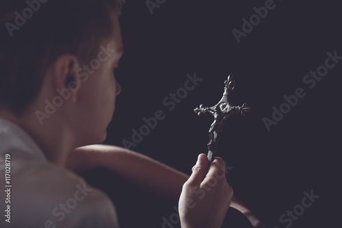 Konstfotografi Contemplative Teenage Boy Holding Ornate Cross