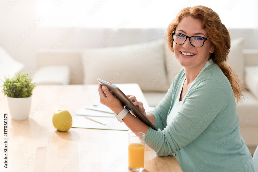 Positive woman working at home