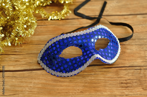 A blue mask isolated on a wooden background