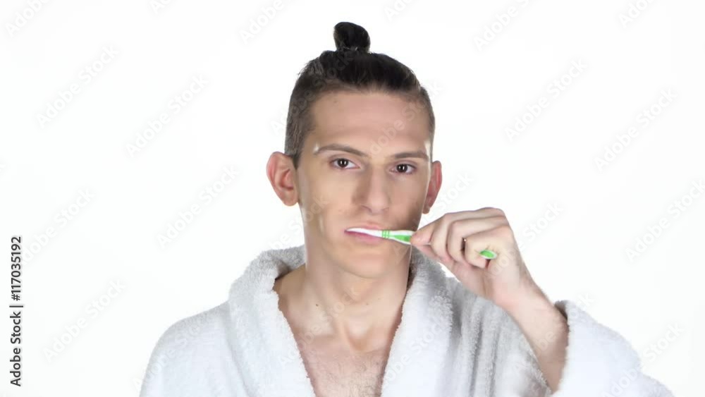 Man brushing his teeth. Isolated on the white background Man brushing his teeth. Isolated on the white background