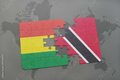 puzzle with the national flag of bolivia and trinidad and tobago on a world map background. photo