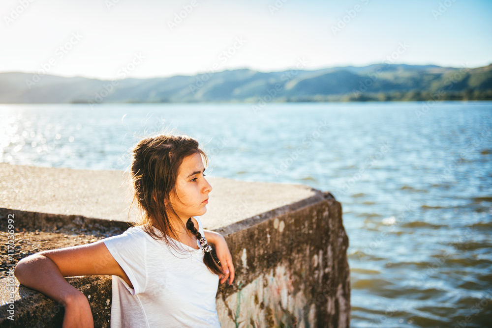 Teenage Girl relaxing by the water