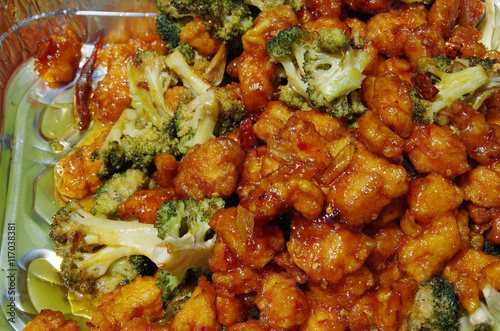 Crispy Chinese chicken and broccoli in picnic tin close up