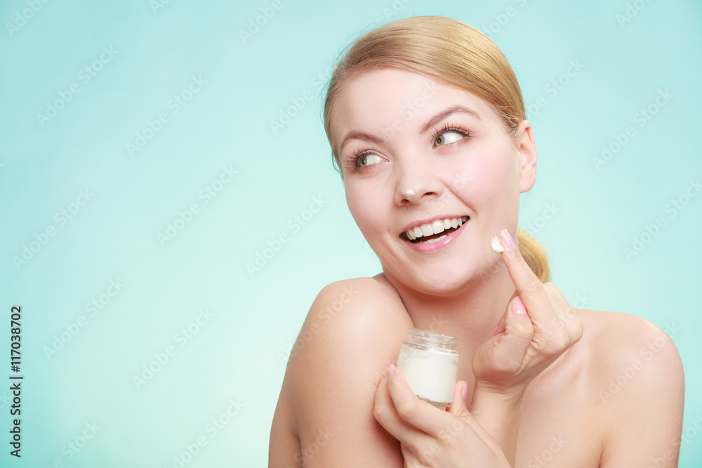 woman applying cream on her skin face. woman applying cream on her skin face.