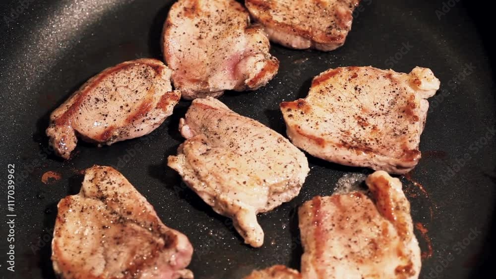 Cooking process of a red organic meat, on a sizzling frying pan, home cook
