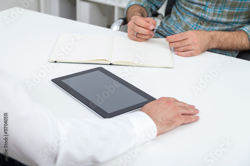 Two men and tablet