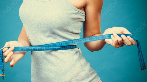 Photography Fitness girl measuring her waistline