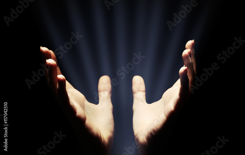 Female hands with light on dark background © Africa Studio