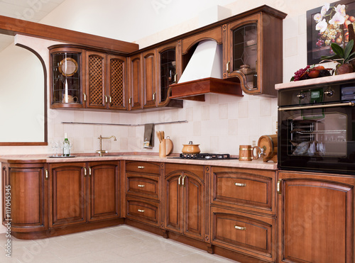 Luxurious new brown kitchen with modern appliances