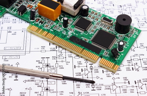 Printed circuit board and precision tools on diagram of electronics, technology