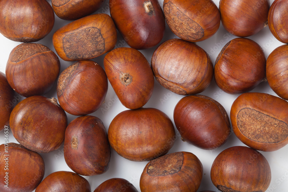 Group of grilled chestnuts. On white background. Autumn background. Group of grilled chestnuts. On white background. Autumn background.