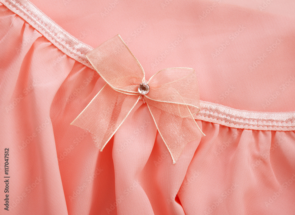 Pink bow on pink fabric dress for background