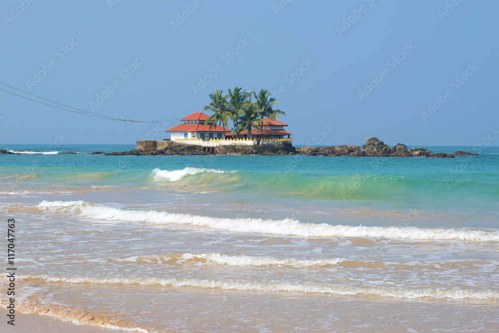 The old Buddhist temple Seenigama Muhudu Viharaya on a small island in the Indian ocean. Hikkaduwa, Sri Lanka The old Buddhist temple Seenigama Muhudu Viharaya on a small island in the Indian ocean. Hikkaduwa, Sri Lanka