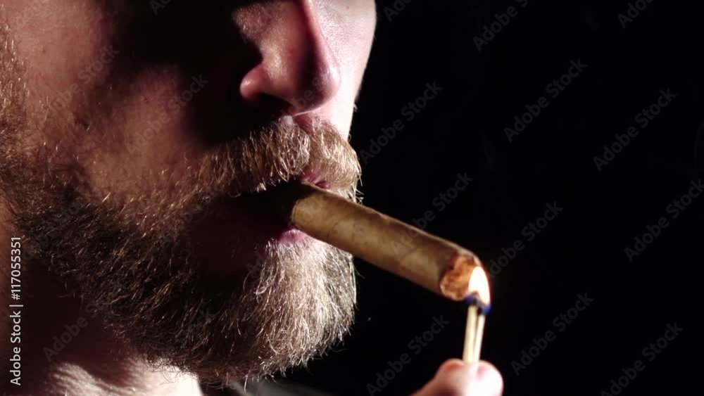 cigarette in dark room Man in a dark room, smoking a cigar. Black. Slow motion. Close up cigarette in dark room Man in a dark room, smoking a cigar. Black. Slow motion. Close up