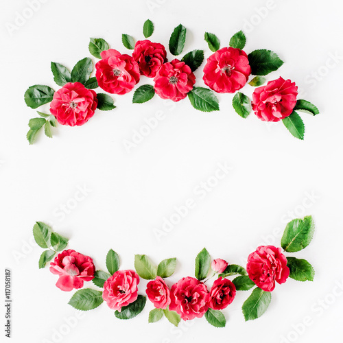 flat lay frame with red roses, branches, leaves and petals isolated on white background. top view