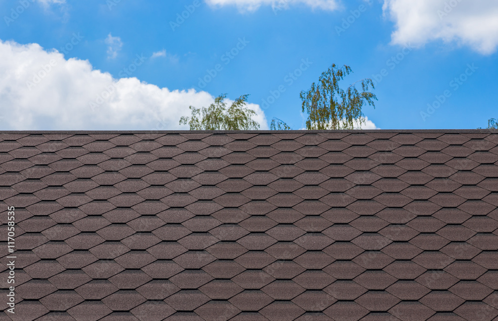 Part of texture with shingles roof and blue sky Part of texture with shingles roof and blue sky