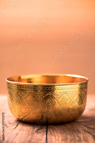 Gold bowl on wood table