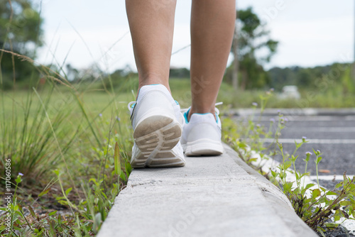 Woman walking on the street alone.