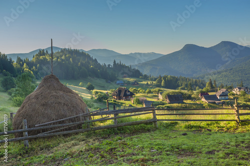 Beautiful summer landscape with village in mountains