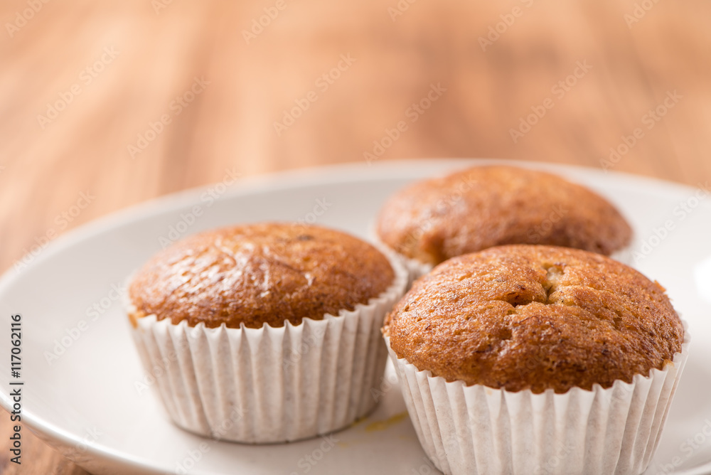 Banana cup cake in plate on wood table