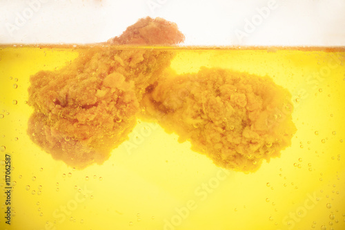 Chicken deep frying in cookink oil photo