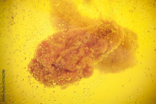 Chicken deep frying in cookink oil photo