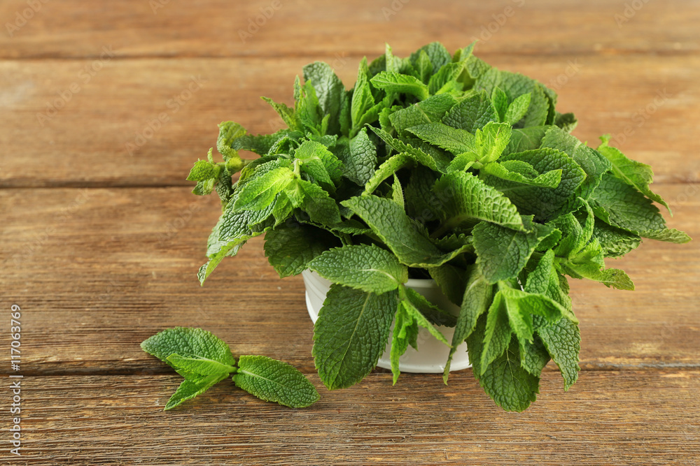 Fresh bunch of mint on wooden table Fresh bunch of mint on wooden table