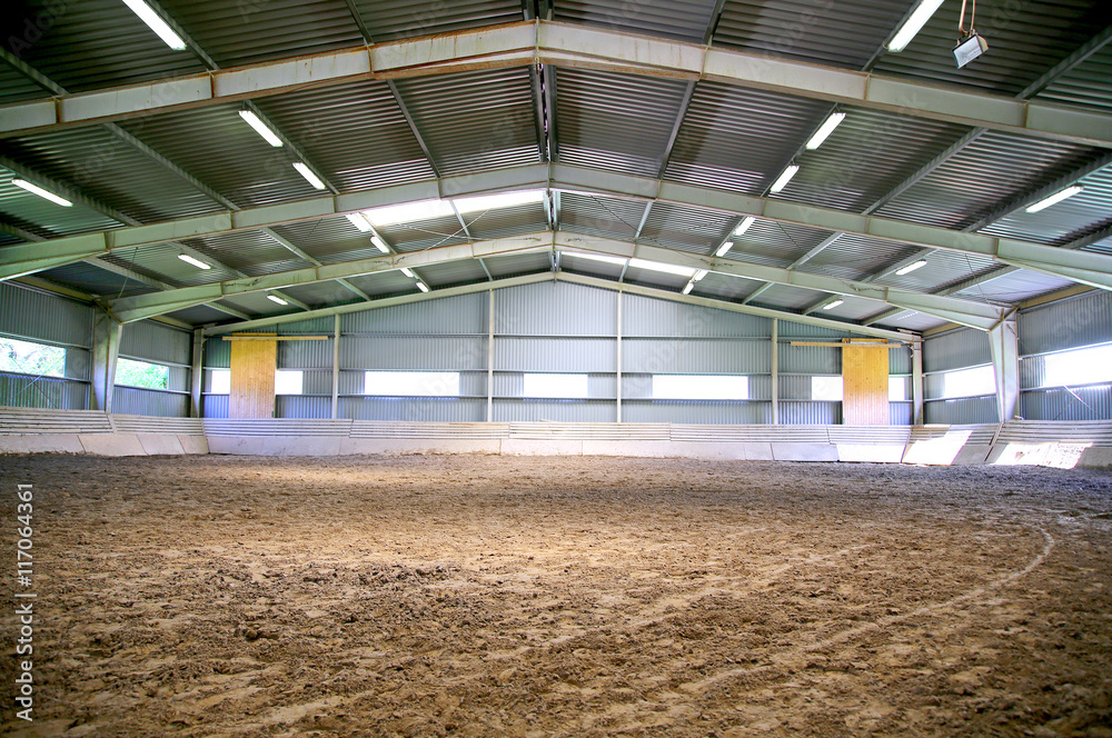 Riding hall with sandy covering without people Riding hall with sandy covering without people