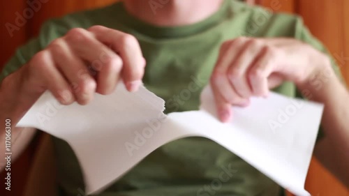 Man tearing a sheet of paper