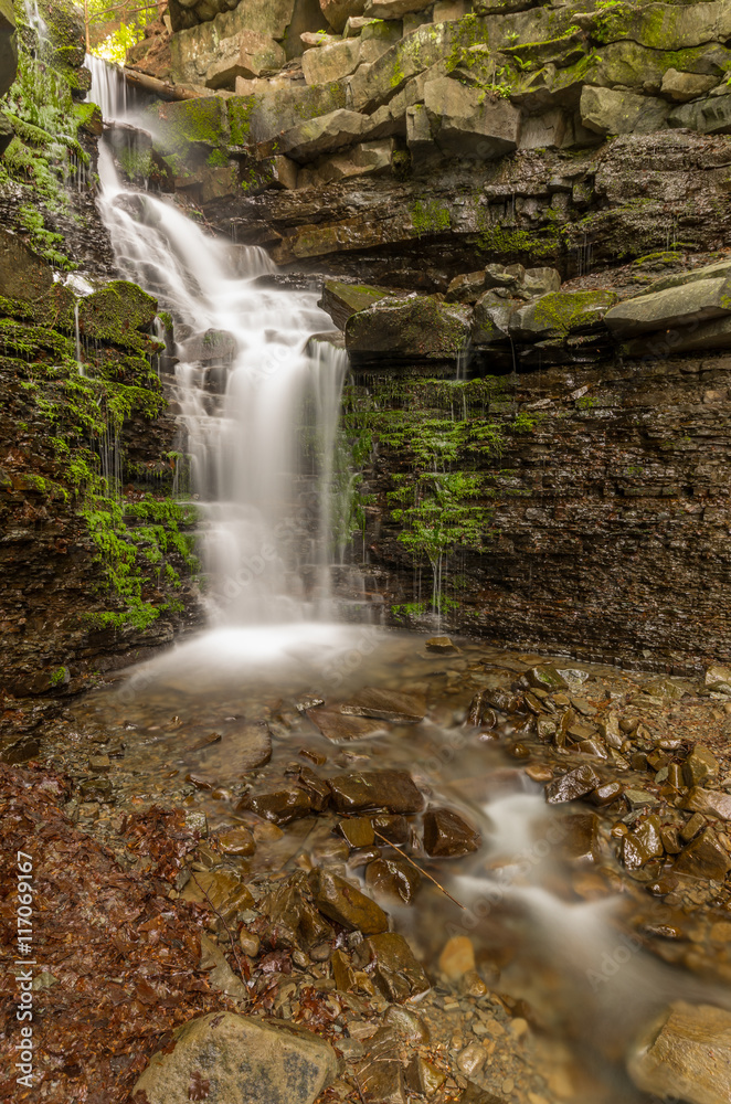 Obraz premium Waterfall Mosorny in Zawoja, Beskid Zywiecki mountain range in Polish Carpathian Mountains