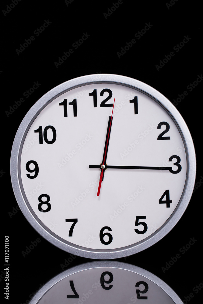 black and white chrome clock on black reflective black and white chrome clock on black reflective