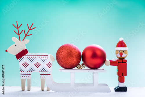 reindeer and snow sled with christmas ball photo