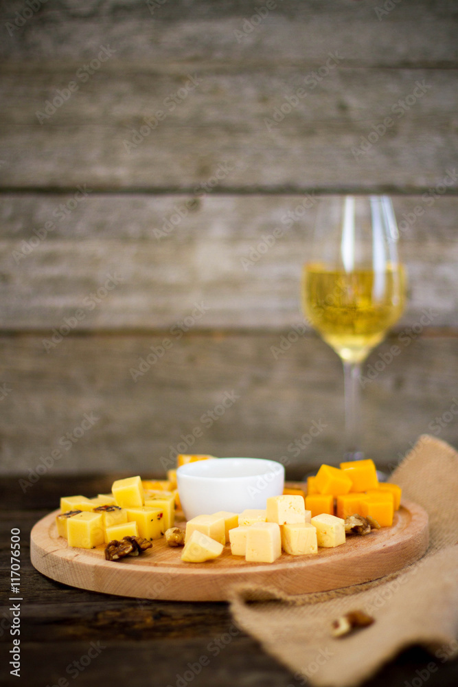 Cheese  and nuts on a wooden background

