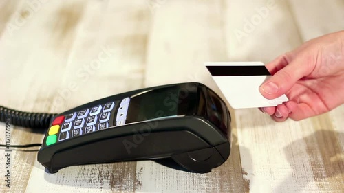 Swipe credit card over pos terminal. Making contactless NFC payment.