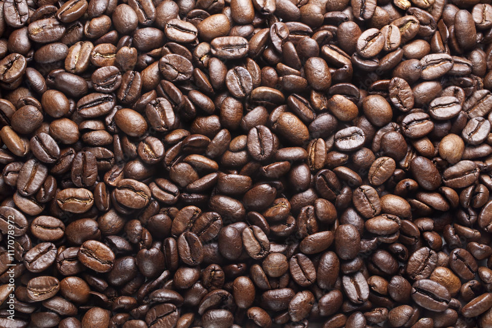 Fototapeta premium vibrant, dry, roasted coffee beans background, top view, sullen 