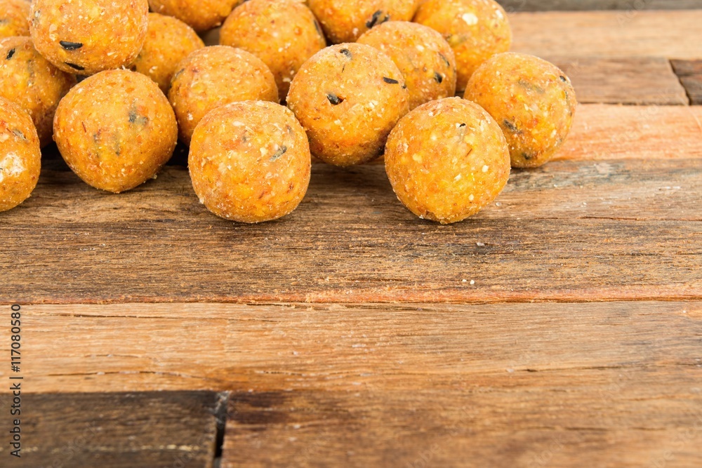 Boilies, fishing baits on wooden background. Macro shot. Boilies, fishing baits on wooden background. Macro shot.