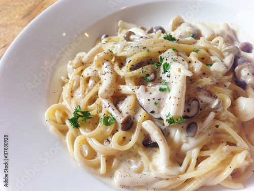 Mushroom cream sauce spaghetti on wooden table - top view
