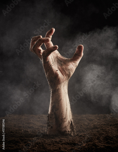 Zombie hand climbs out of the ground