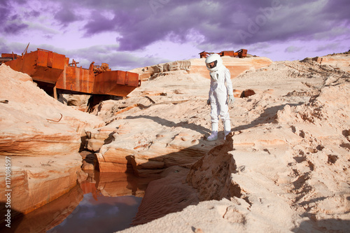 Fototapeta Naklejka Na Ścianę i Meble -  futuristic astronaut on another planet, Mars. image with the effect of toning