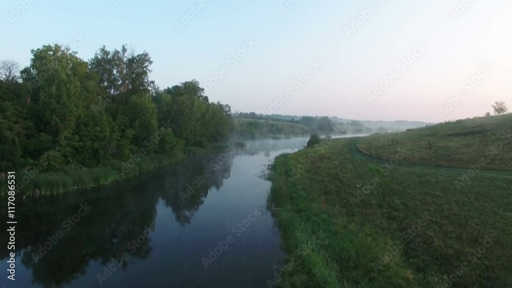 Aerial video of a big lake at sunrise while fog creeping over the water. Drone moving forward. 4K Aerial stock footage shot at summer season time.
Aerial video of a big lake at sunrise while fog creeping over the water. Drone moving forward. 4K Aerial stock footage shot at summer season time.